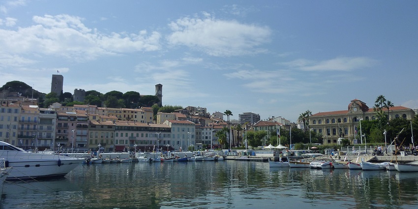 Things to do in Cannes in June include strolling through the cobbled, historic streets of Le Suquet with colourful old buildings.