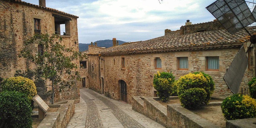 Stone archways, narrow alleys, and historic buildings in the beautifully preserved medieval town of Pals.