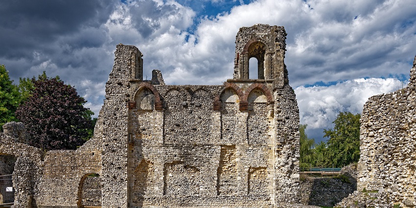 Ruins of Wolvesey Castle with visitors wandering through the medieval stone walls and open green spaces.