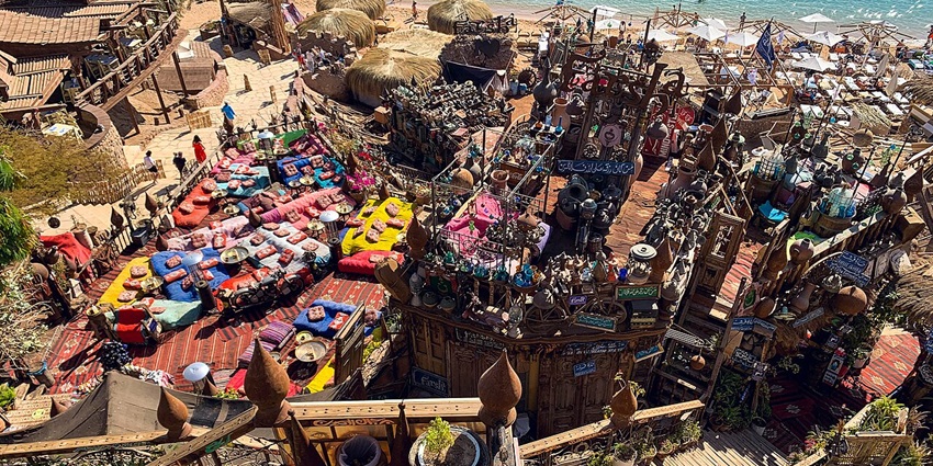 Colorful beachside café with stunning décor and vibrant seating, a must-visit for things to do in Sharm El Sheikh.
