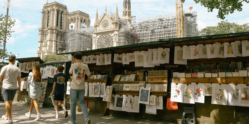 An elegant Parisian street is lined with fashion boutiques and stylish window displays.
