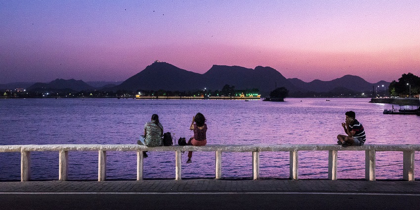 A serene lake framed by hills and clouds, popular for boat rides and evening strolls.