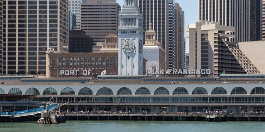 Port of San Francisco building with clock tower, set against tall modern office buildings.