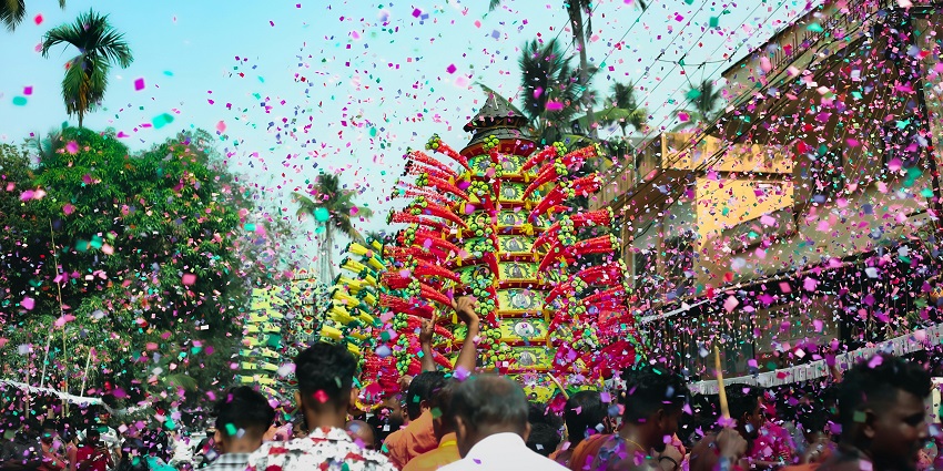 Vibrant Onam celebration with floral rangoli and traditional attire in Kerala — what is the best time to visit Kerala