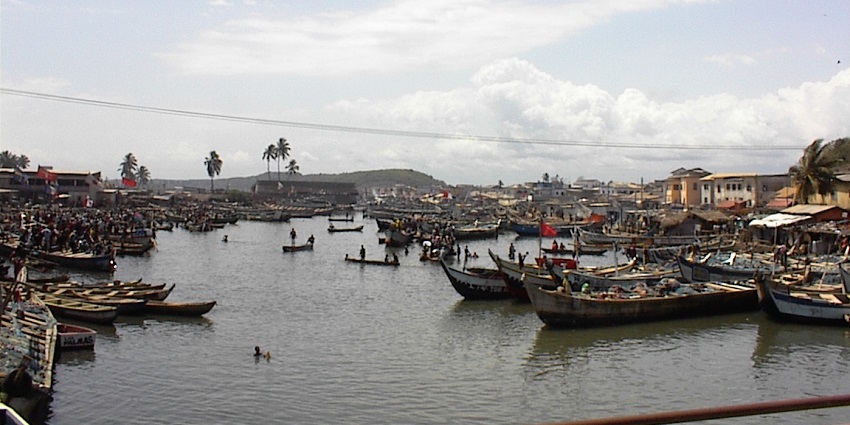 Islands in Ghana with serene waters and local boats dotting the shore.