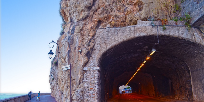 A tunnel going below the structure of Fort Antoine with people standing near the street lamp