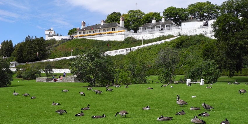A scenic view of Fort Mackinac with lush greenery, one of the top historical places in Michigan.