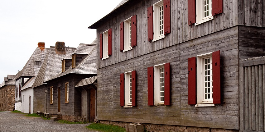 Fortress of Louisbourg with black & grey architecture, multiple windows and a street