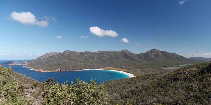 Discover pink granite peaks and the perfect curve of Wineglass Bay in Freycinet National Park, among the best things to do in Tasmania.