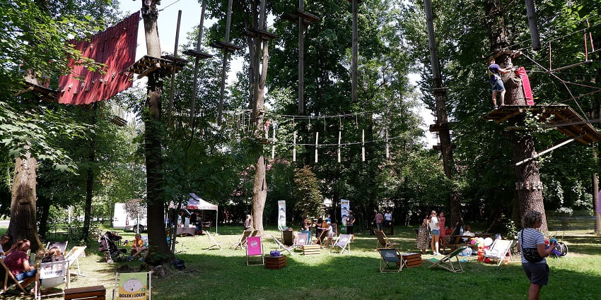 People engaged in various activities at an adventure park in the UAE on a perfect sunny day.