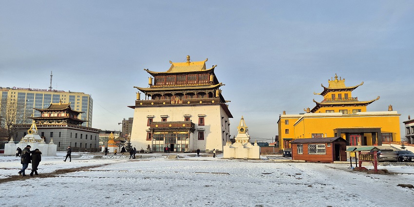 Gandan Tegchinlen Monastery with traditional Buddhist architecture and people visiting
