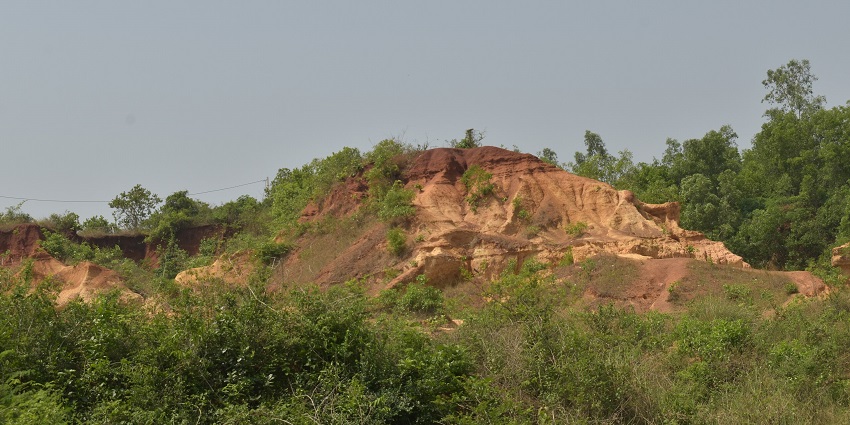 Gangani near Garhbeta with rugged laterite cliffs surrounded by patches of greenery.