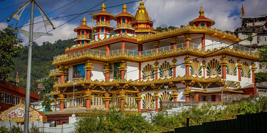 Hilltop temple in monsoon mist, one of the spiritual places to visit in Sikkim in August.