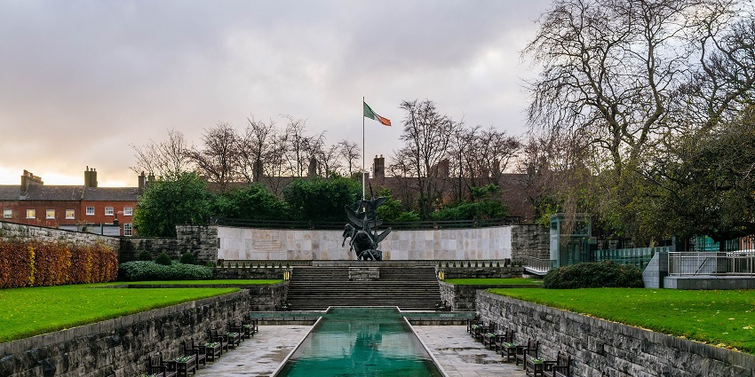 Garden of Remembrance in Dublin with trees, benches, memorial, and an Irish flag