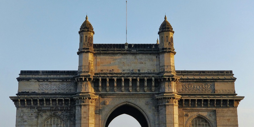 Iconic arch monument overlooking the Arabian Sea, symbolising Mumbai’s colonial past and pride.
