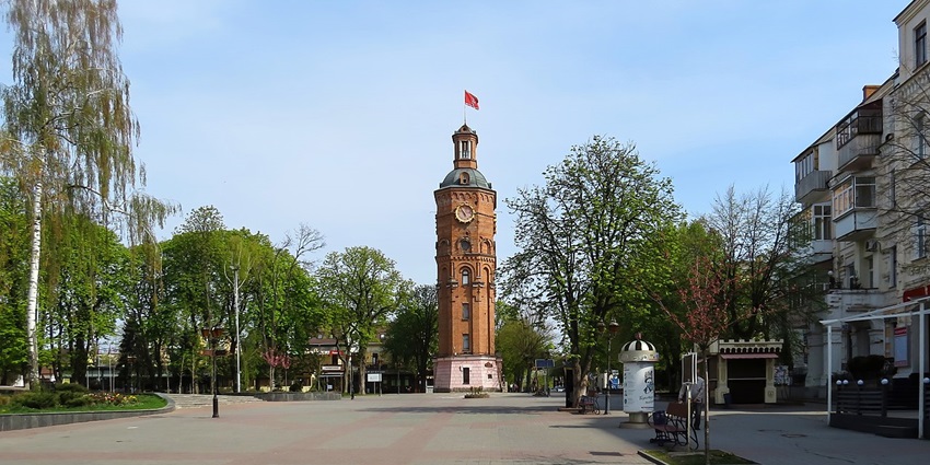 Vinnytsia Water Tower rises tall beside neatly paved paths and small landscaped gardens.