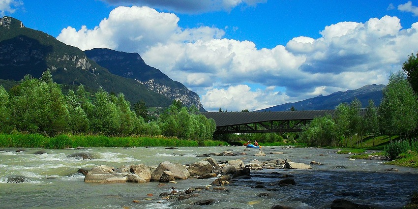 Raft plunging through wild rapids in the Dolomites’ valleys.