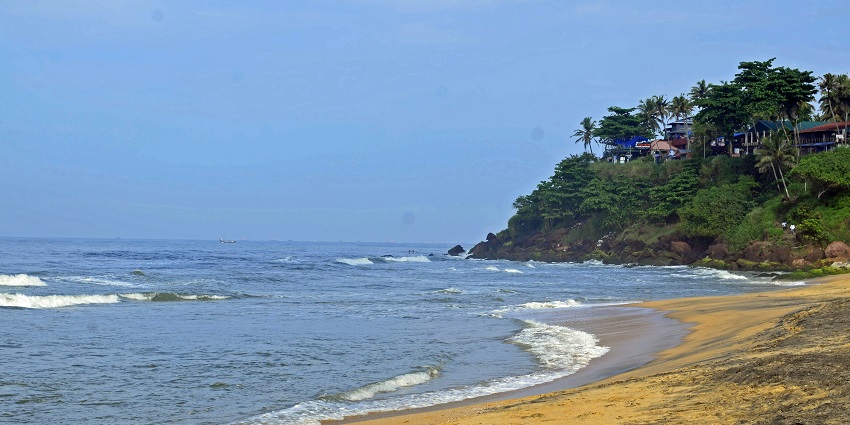 Gopalpur sea beach with high tide waves, with sandy shores, palm trees, one of the best places to visit in Odisha in August.
