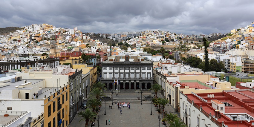 Colourful buildings cascade down cliffs in Gran Canaria, one of the scenic Canary Islands