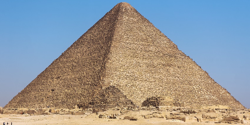 Majestic ancient pyramid with limestone casing stones, towering in the desert outside Cairo as a wonder of the ancient world.