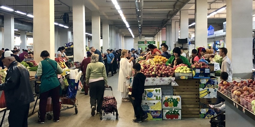Bustling Green Bazaar in Almaty filled with colorful stalls and fresh local produce.