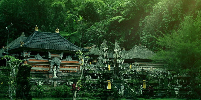 Gunung Kawi Sebatu Temple with detailed architecture, multiple statues and greenery.