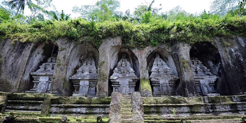 Moss‑covered ancient shrines carved into cliffs at Gunung Kawi Temple, one of the top places to visit in Bali in February.