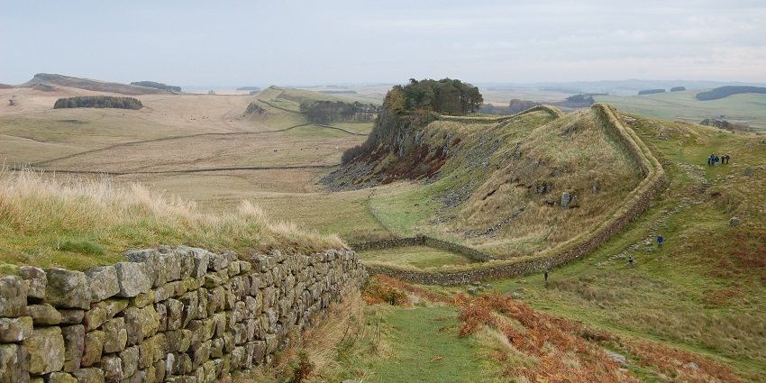 Hadrian’s Wall, with a small line of wall made up of stones and surrounded by greenery.