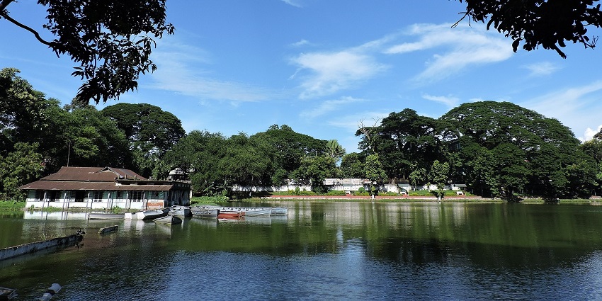 Haflung Lake with a greenish water body, and green trees, one of the best places to visit in Assam in December.