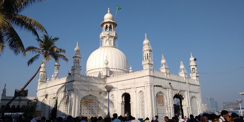 Haji Ali Dargah and tomb located off the coast, connected by a walkway during low tide.