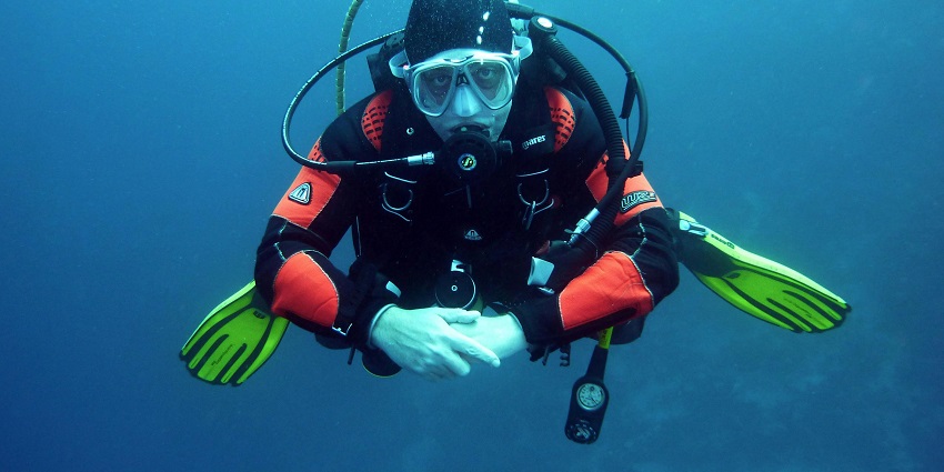 Experience the thrill of diving at Hanifaru Bay, exploring vibrant coral reefs and diverse marine life in pristine waters