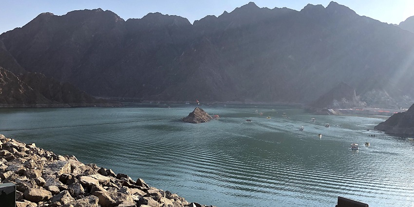 The splendid Hatta Dam in the UAE is surrounded by the Hajar Mountains on a perfect sunny day.