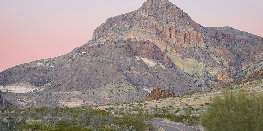 The dark desert landscape of Big Bend National Park under a starry night sky, perfect for stargazing.