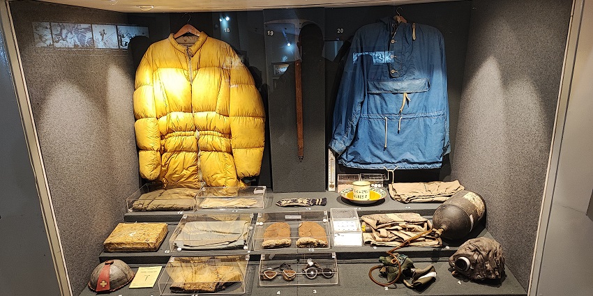 Inside the Himalayan Mountaineering Institute with jackets and an oxygen tank on display.