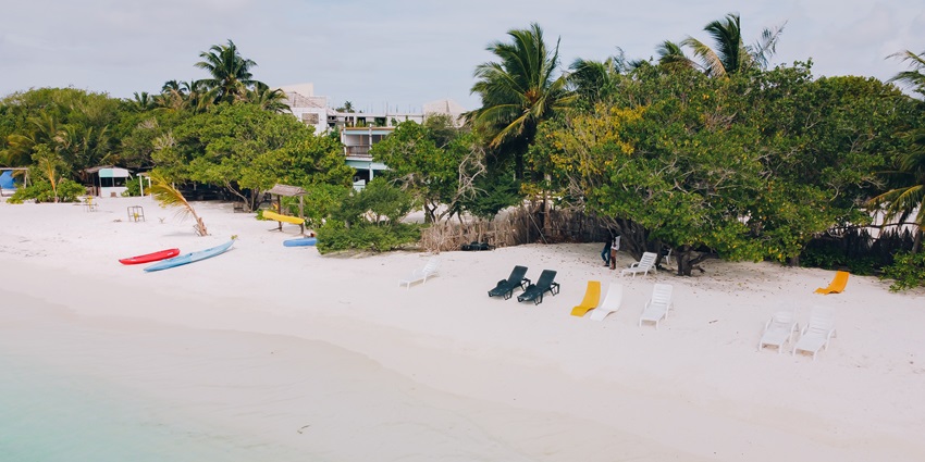 Beach at Himmafushi island from above, with multiple lounge chairs, one of the top places to visit in Maldives in January.