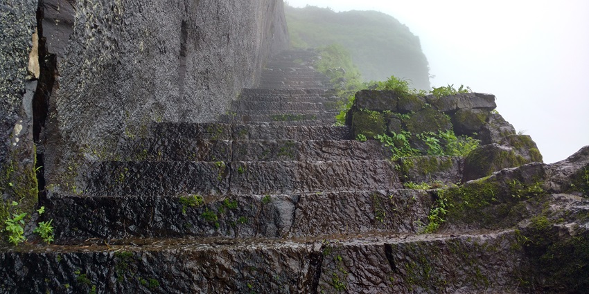A historic Kenjalgad Fort structure showcasing its ancient stone walls and architecture.