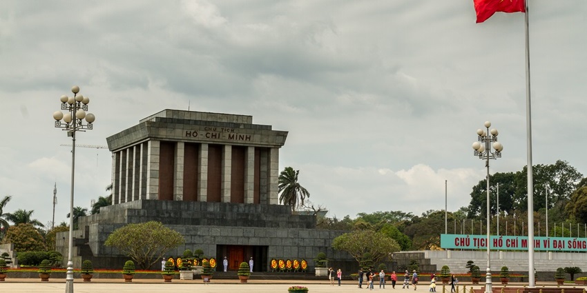 Ho Chi Minh Mausoleum, with a large Vietnamese flag, is one of the historical places in Hanoi