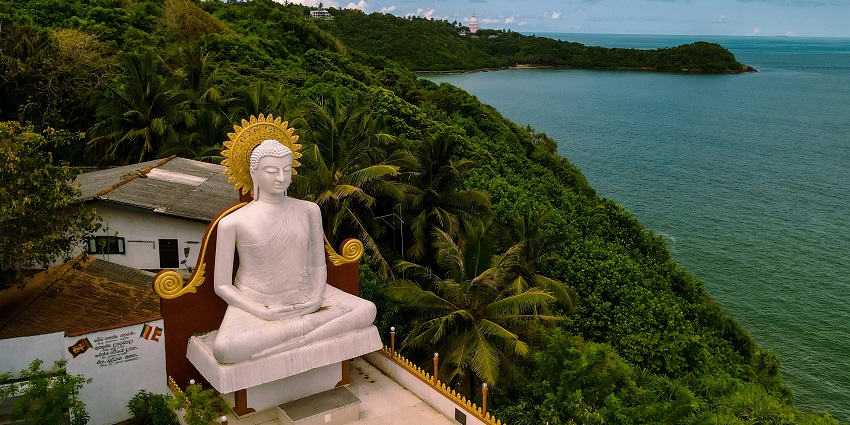 Peaceful waterfront scene reflecting on which month is best to visit Sri Lanka.