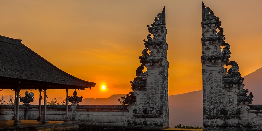 Beautiful sunset at the Pura Lempuyang Luhur temple, known as the 'Gates of Heaven', with warm orange sky