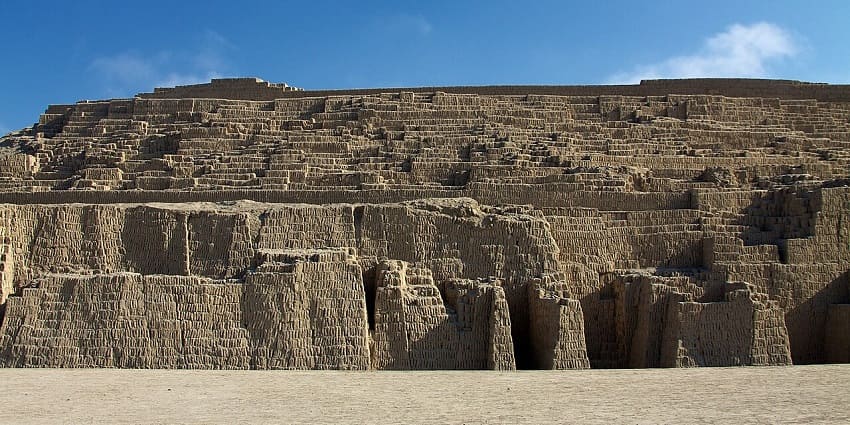 Hauca Pucllana in Lima, with ancient structures and ruined architecture against the bright blue sky