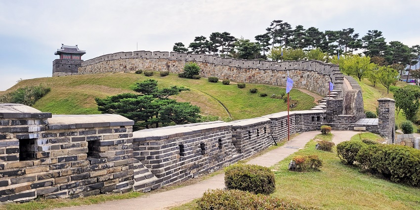 A view of Hwaseong Fortress in South Korea, showing ancient stone walls, one of the famous monuments in South Korea.