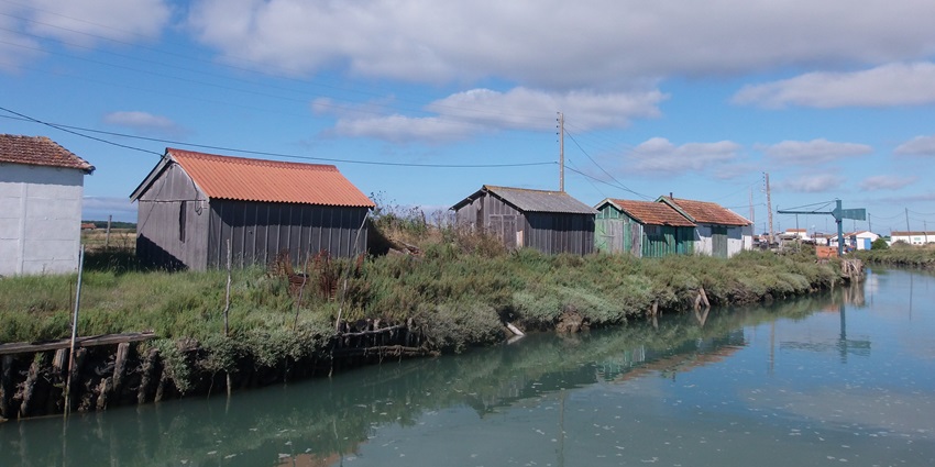 Scenic view of Arceau's clear canals and channels on Île d’Oléron, France, in July 2016