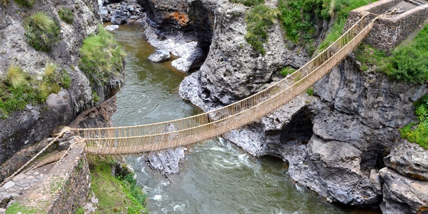 The Inca Bridge at Machu Picchu historical places a cliff-edge path with wooden planks.