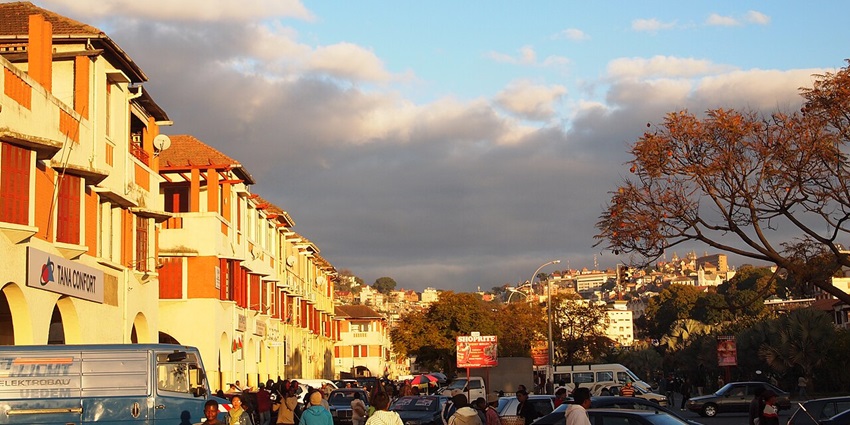Avenue de l'Indépendance in Antananarivo, Madagascar, with busy roads and a cloudy sky.
