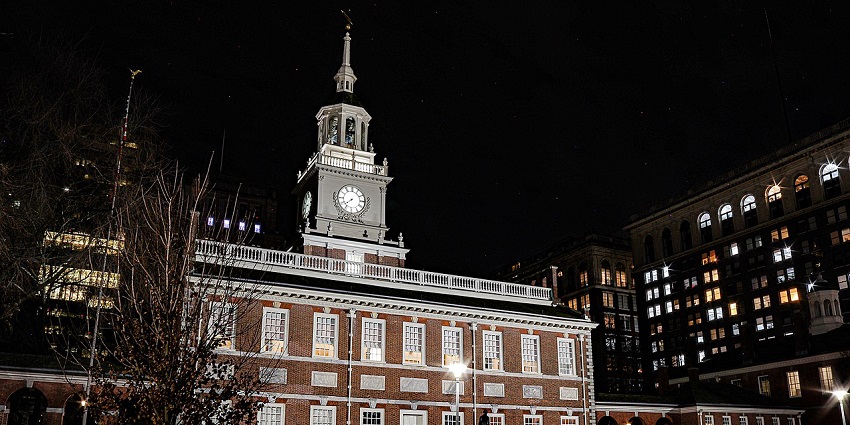 Independence Hall at night with detailed architecture, a clock on top of the building, one of the historical places in Philadelphia.