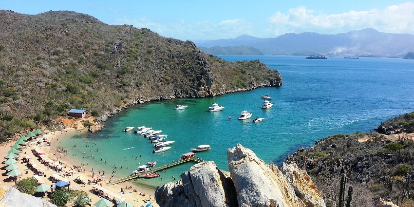 A cluster of small islands off Venezuela's coast with calm waters, beach spots, and lush tropical views.