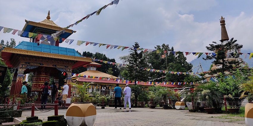 Buddhist temple in Itanagar with traditional architecture, decorated with Tibetan flags