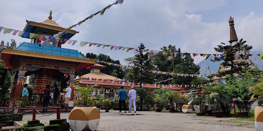 Buddhist temple in Itanagar with traditional architecture, decorated with Tibetan flags