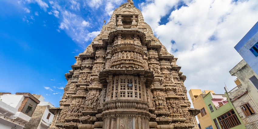 A Hindu temple in Udaipur with intricate stone carvings and a steep staircase entrance.