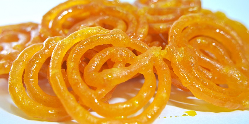 Crispy, orange jalebi coils soaked in saffron-infused sugar syrup, served warm and sticky.